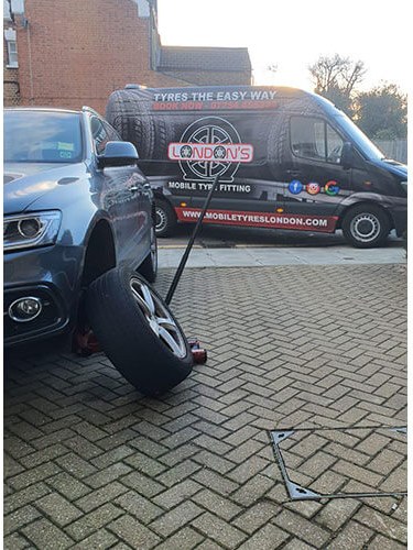 Wheel removed from a customer's car with the Mobile Tyres Today van in the background